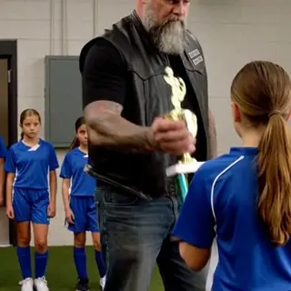 A Biker Smashed a Girl’s First Soccer Trophy in Front of Her Entire Team — What Fell From the Broken Base Silenced Every Parent